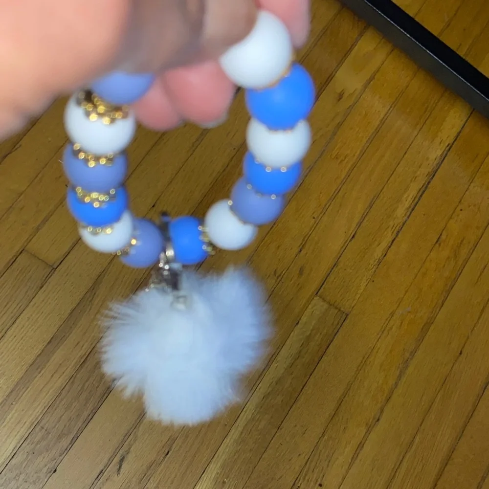 Blue and white bracelet keychain with white pom-pom